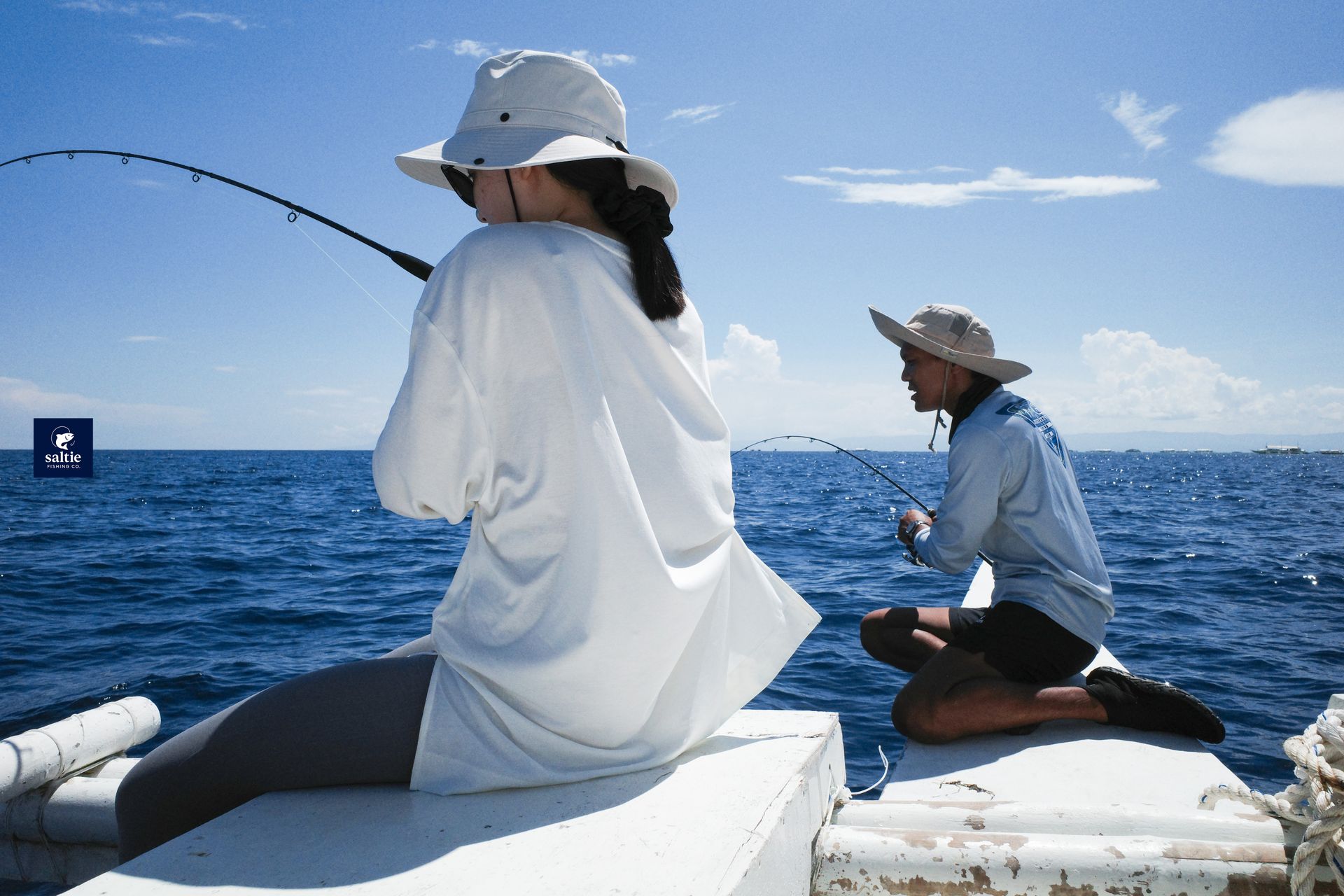 Two guests fishing together on the boat in Bohol
