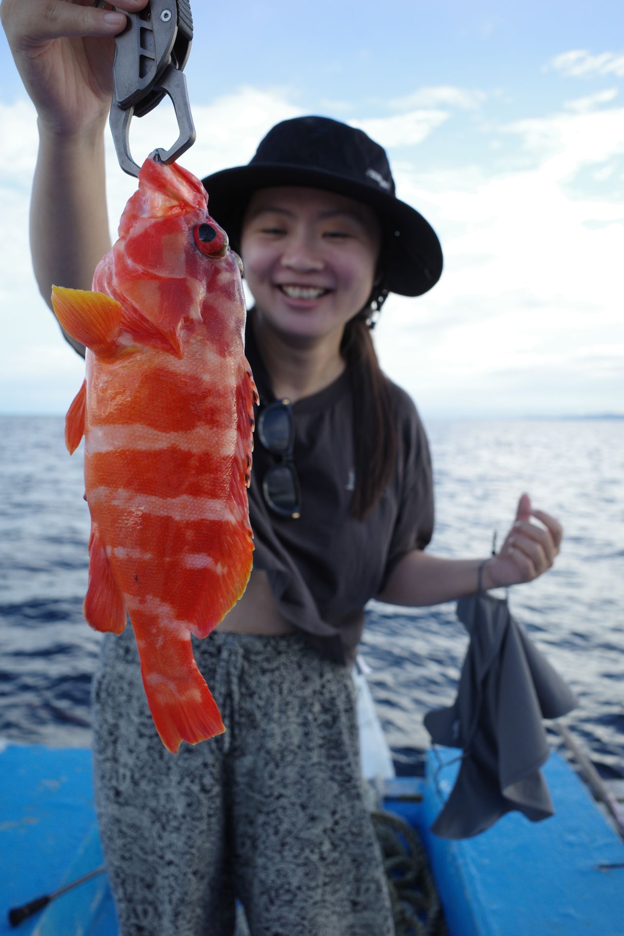 A Saltie guest showing her catch on the boat